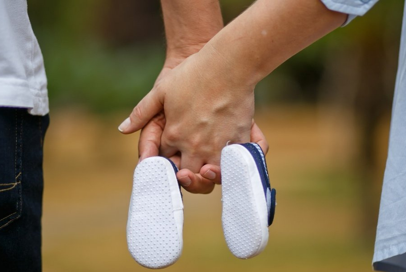 Couple walking with baby shows