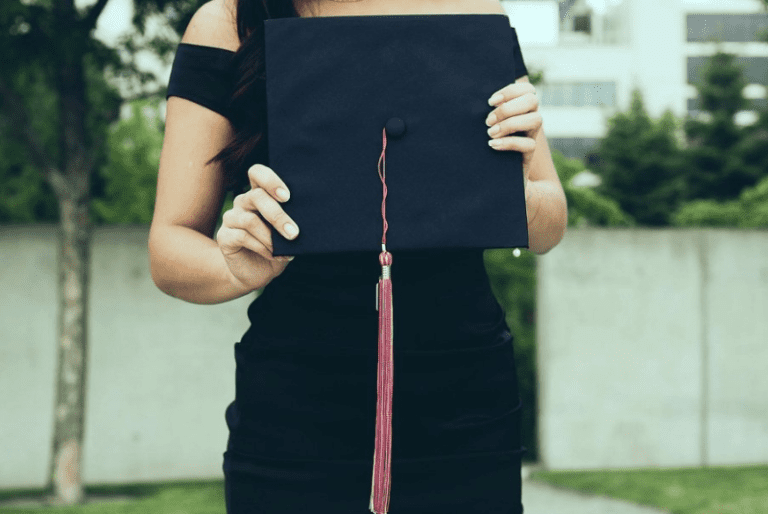 Woman holding a graduation cap